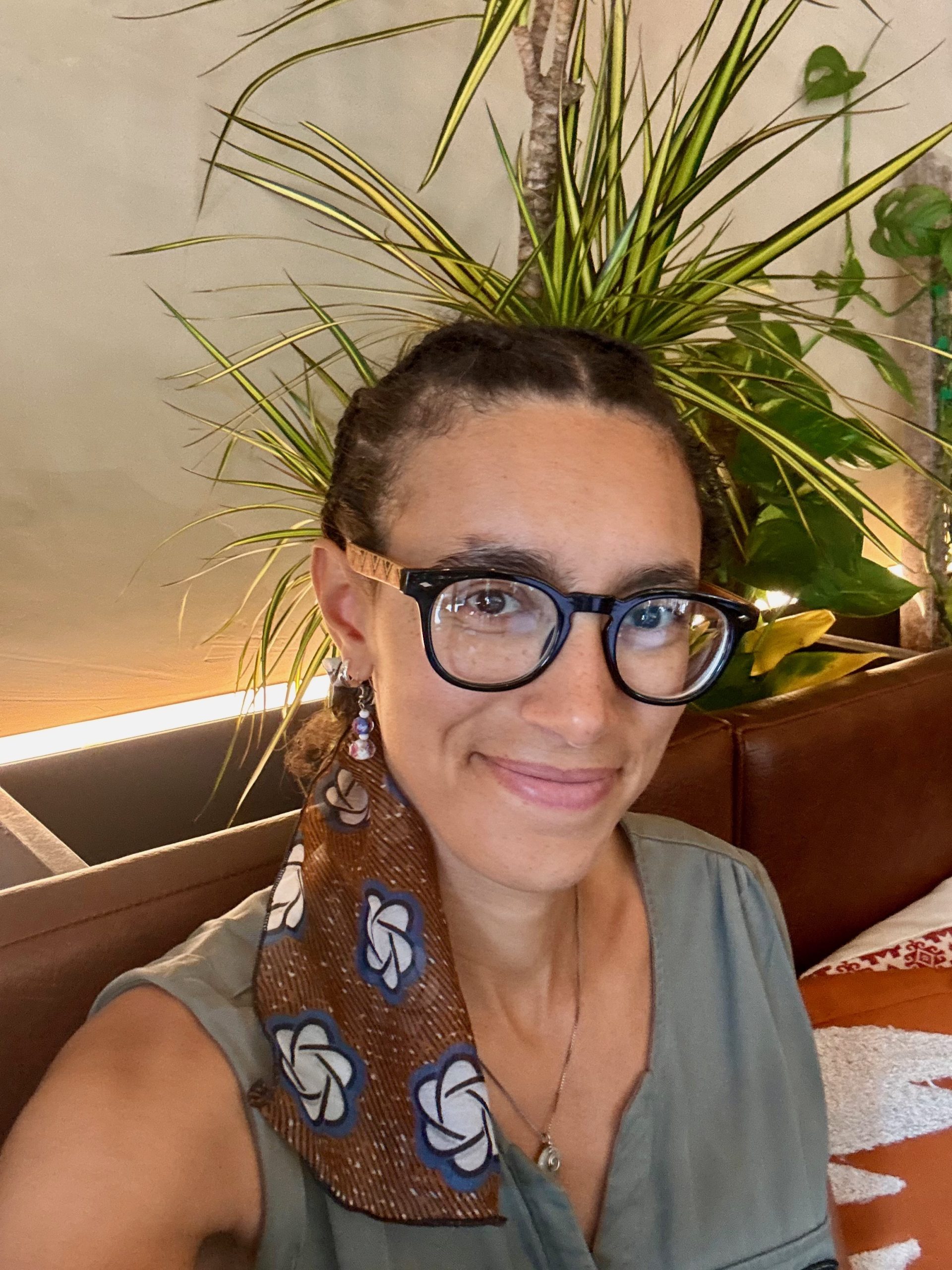 Juju, founder of Gentle Root Studio, smiling in a portrait photo