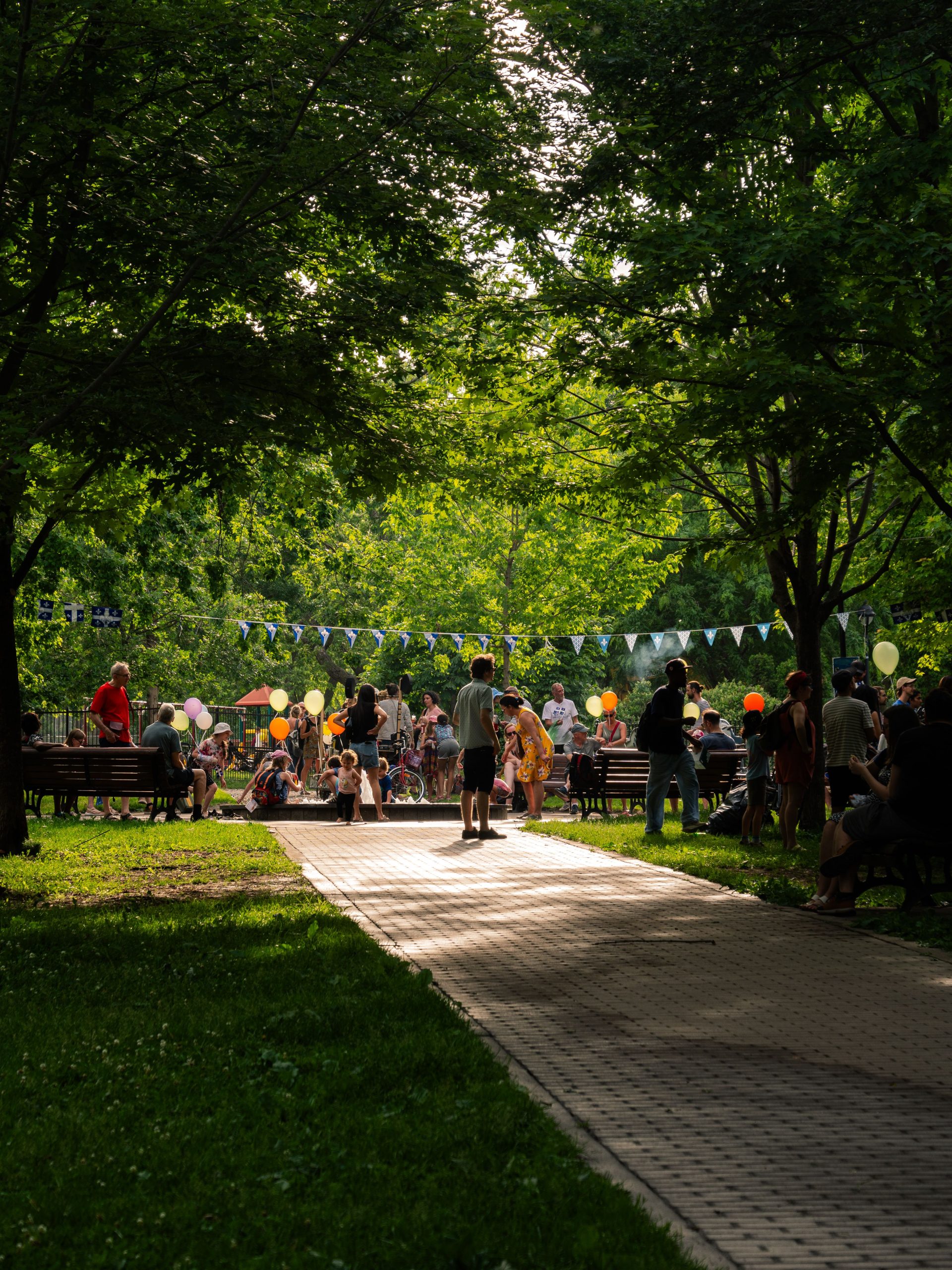 Community gathering outdoors with bunting and balloons