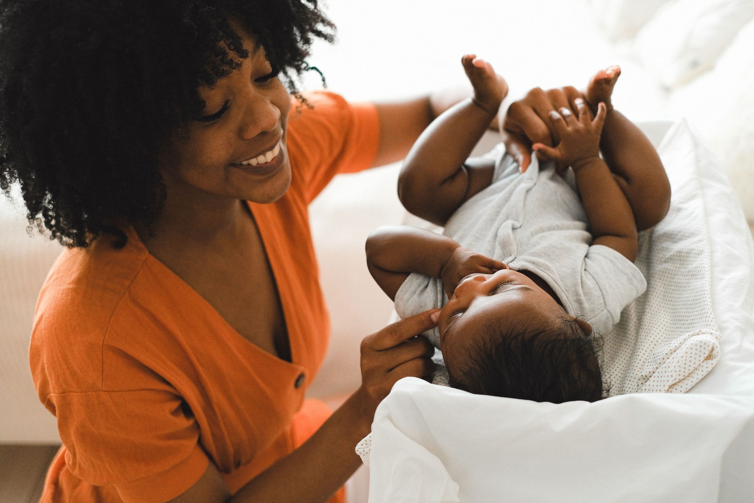 Parent laughing with baby during an infant massage class
